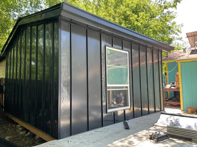 Black standing seam metal wall panels for Roof Inspection in Brenham