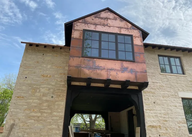 Copper metal panel facade on a stone building for Skylight Installation in Brenham