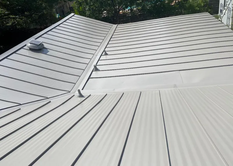 Solar attic fan installed on a metal roof for Roof Ventilation in Brenham